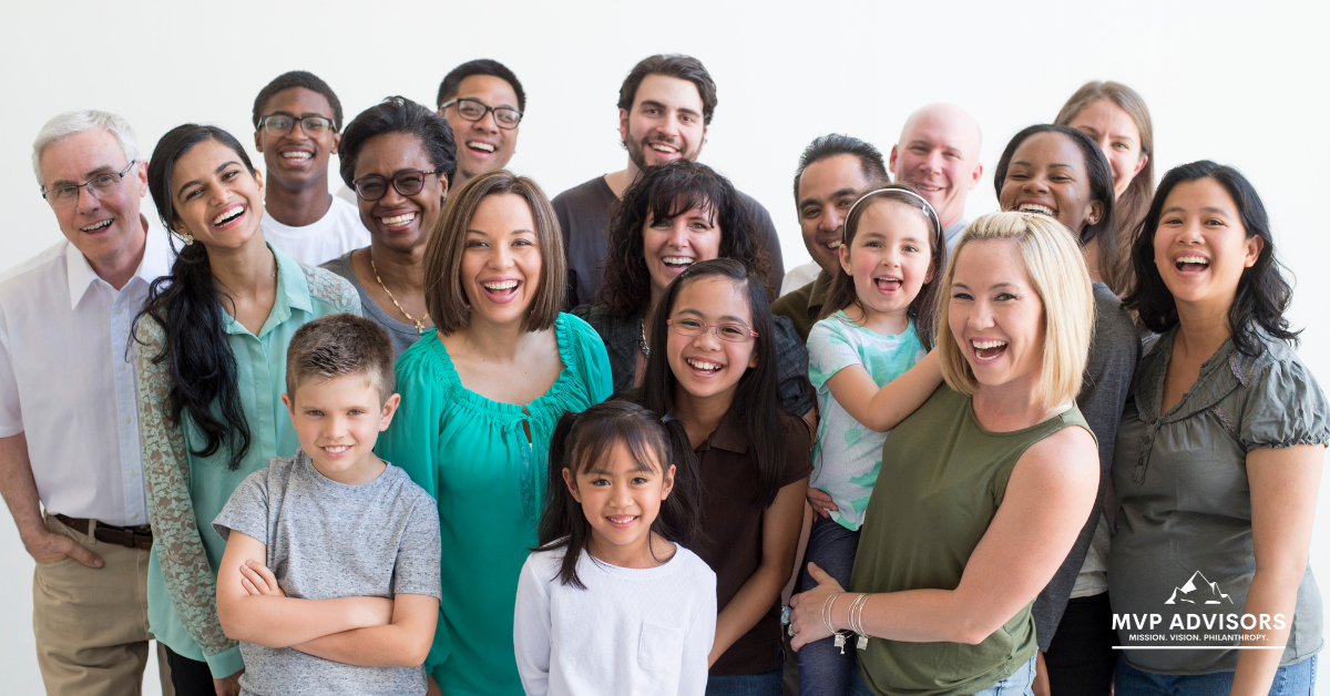 Blog header image featuring a large group of people of diverse backgrounds, cultures, genders, and ages, all smiling at the camera to represent a potential nonprofit target audience