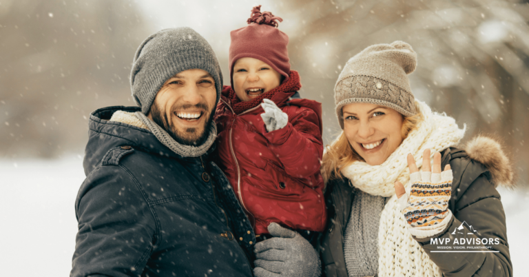 Family including a mom, dad, and young child smile in a header for the Winter Fundraiser Ideas blog